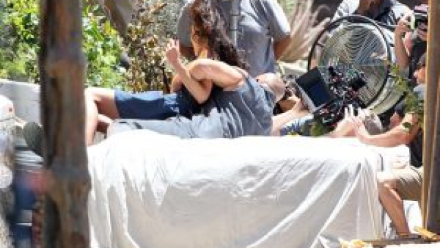 Vin Diesel plays the hero as he sweeps Jordana Brewster out of harm’s way during the filming of an intense house explosion scene for Fast & Furious 7.